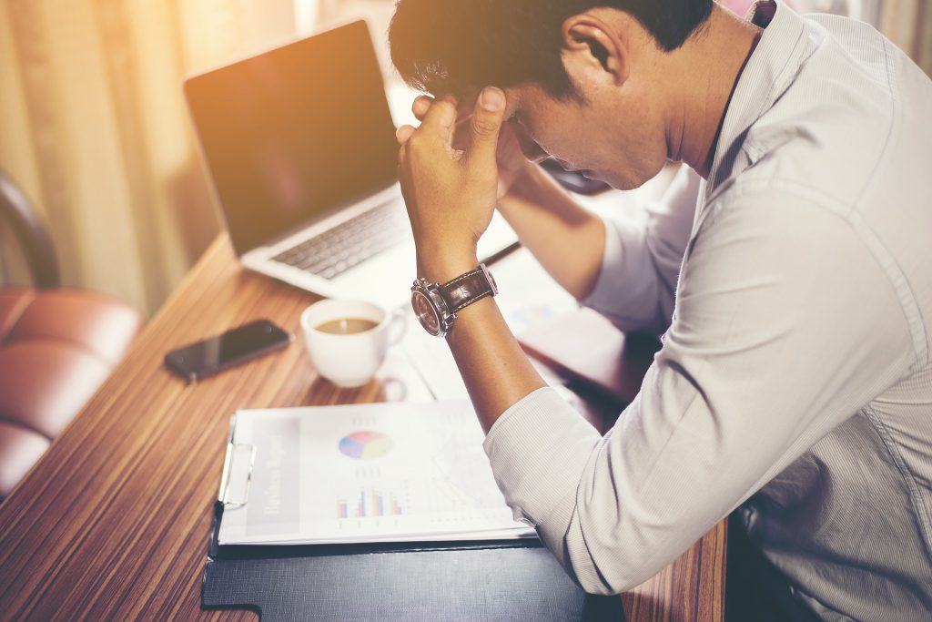 stressed man at work for blog by Wellspace on employee mental health