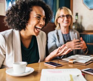 two colleagues laughing for blog from wellspace on corporate wellness programme