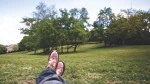 business man putting his feet up in a park to illustrate blog on mental resilience from Wellspace