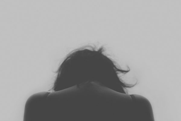 woman with head down for blog by Wellspace on national Stress Awareness Week