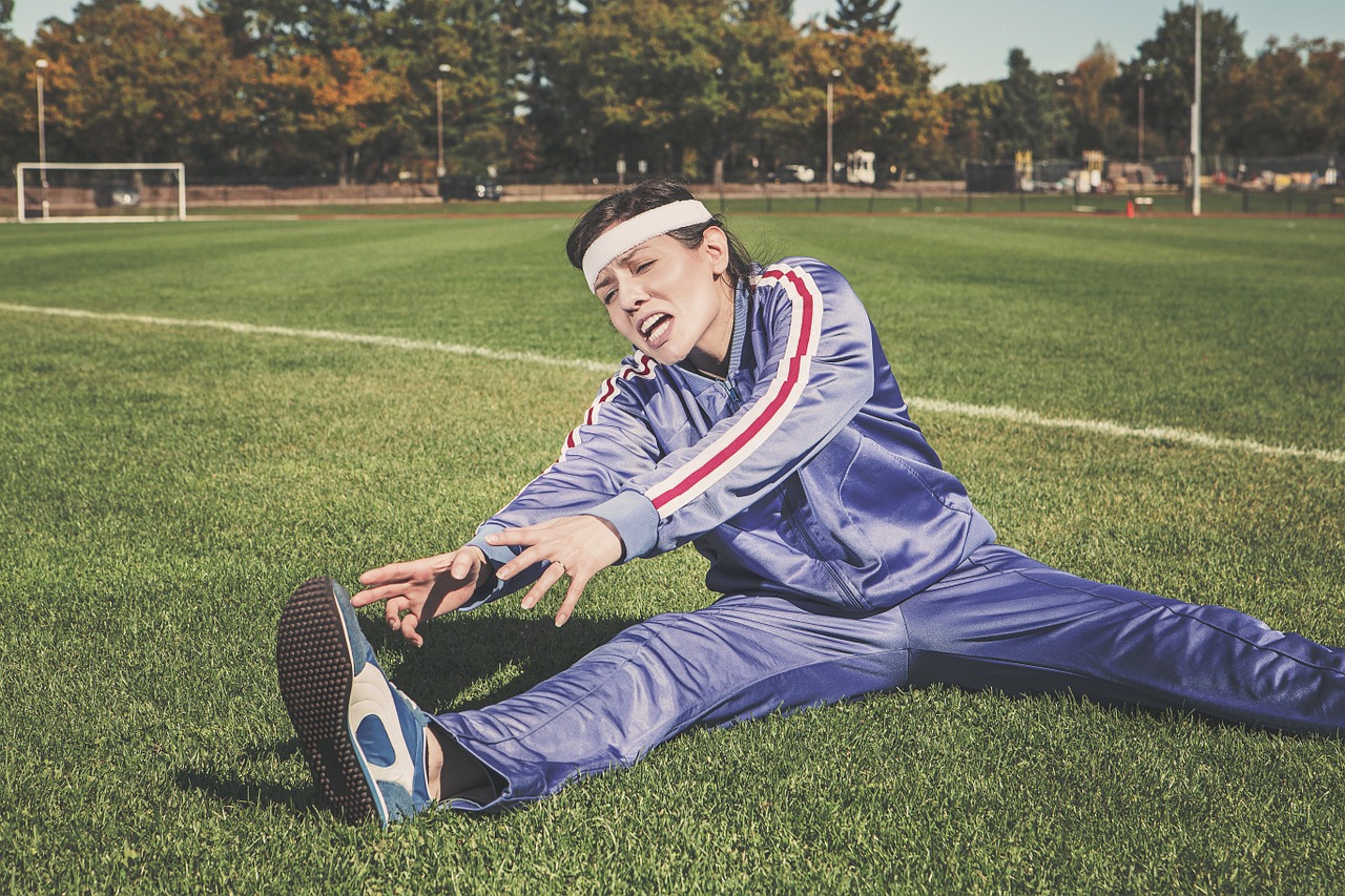 woman stretching in tracksuit to represent blog by Wellspace on choosing a wellbeing programme