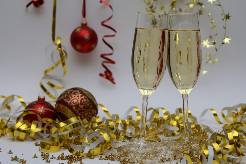 two glasses of champagne for blog by Wellspace on practicing inclusivity during the holidays in the workplace