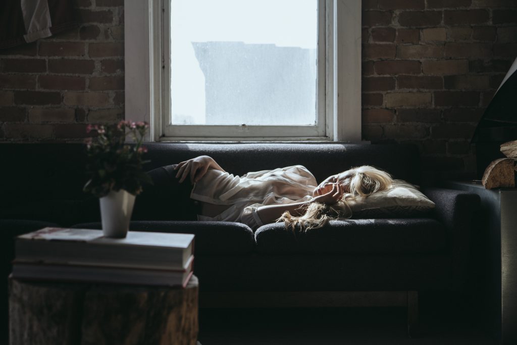 woman relaxing on a bed after having had a stressful week at work 