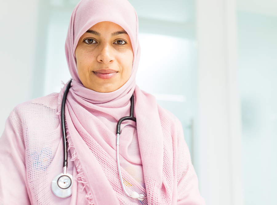 Muslim Arabic female doctor at hospital who is having a happy 9-5 for workplace wellness blog