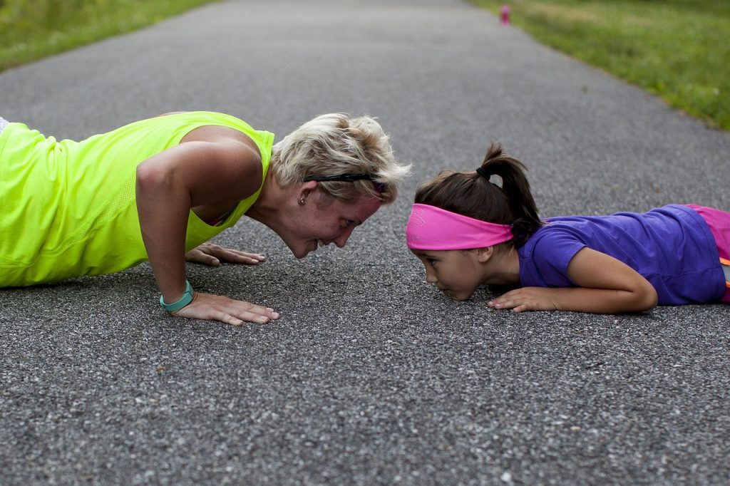 Image of woman and child doing push ups for blog by Wellspace on how much exercise is recommended