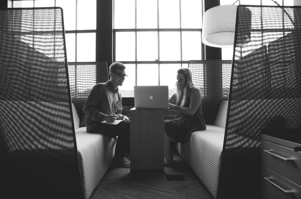 image shows two people working in a tidy office