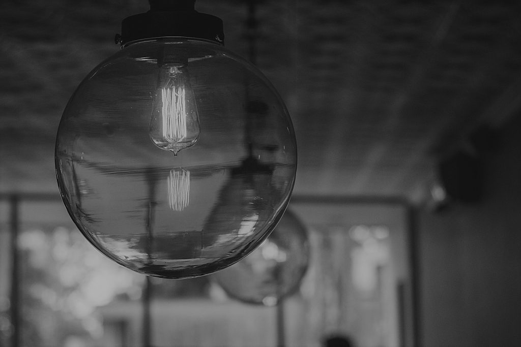 image shows several light pendants with dim bulbs