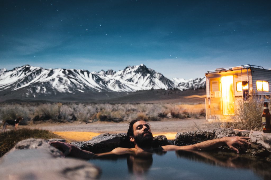 man relaxing in a spring bath ater a stressful week at work 