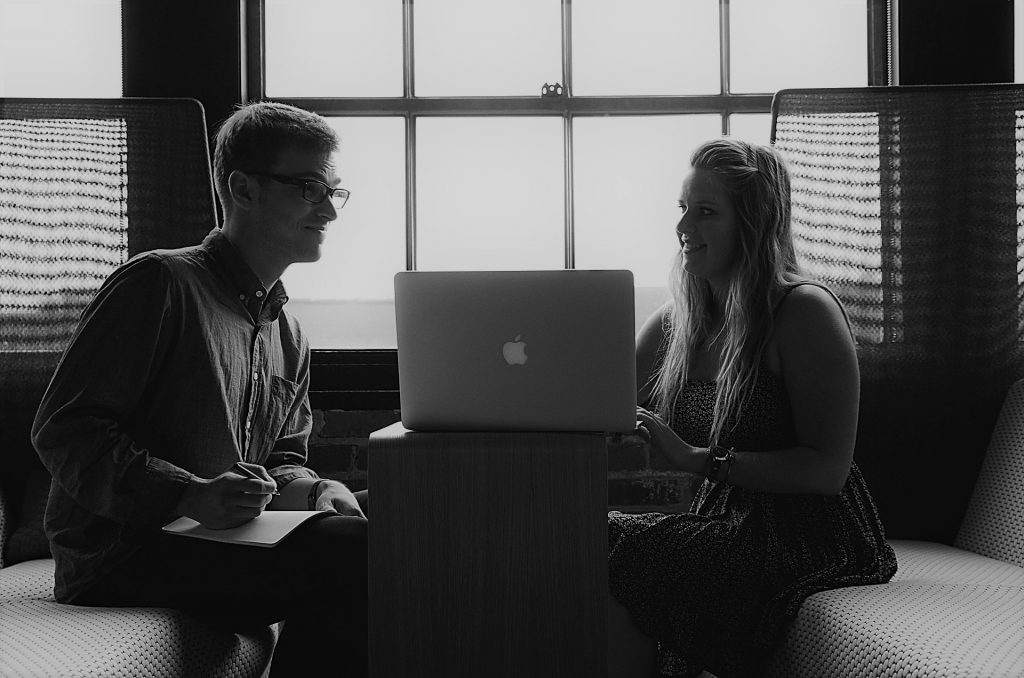 image shows two colleagues talking