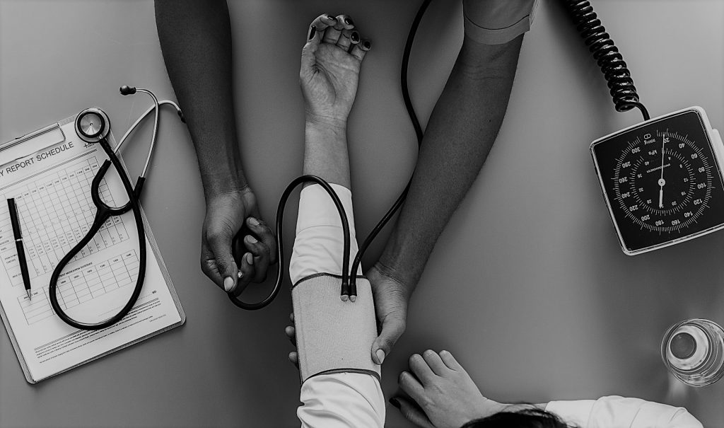 image shows a a doctor checking a patient