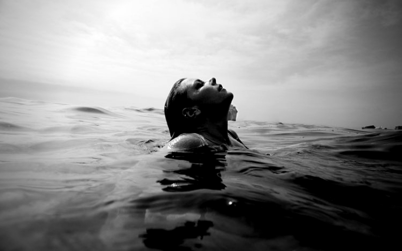 Woman rising up from water to represent equal work life balance for International Women's Day 2019