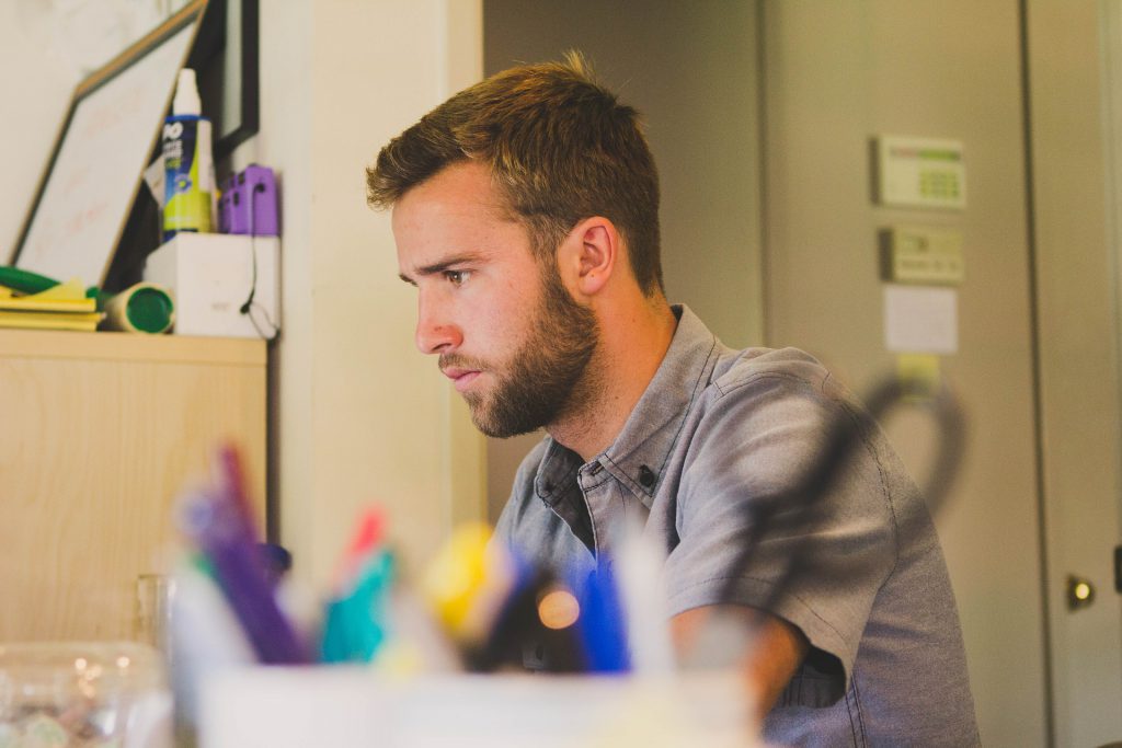 image of man at a desk concentrating for blog by wellspace on workplace wellbeing and productivity 