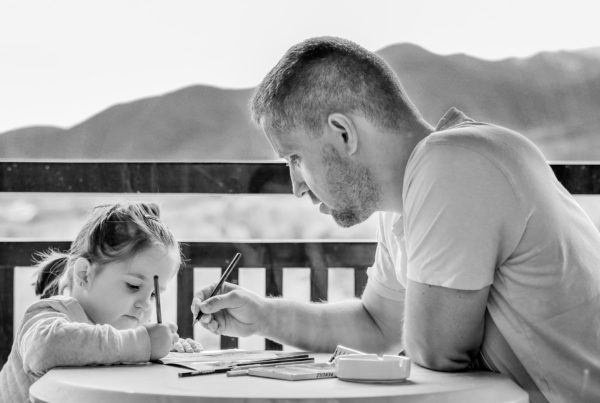 image of a dad with a little girl for blog on surviving the summer holidays for working parents