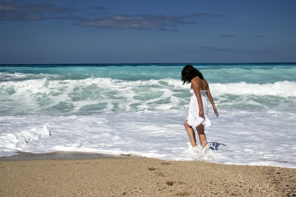 relaxing on beach on a micro holiday to improve health and wellbeing