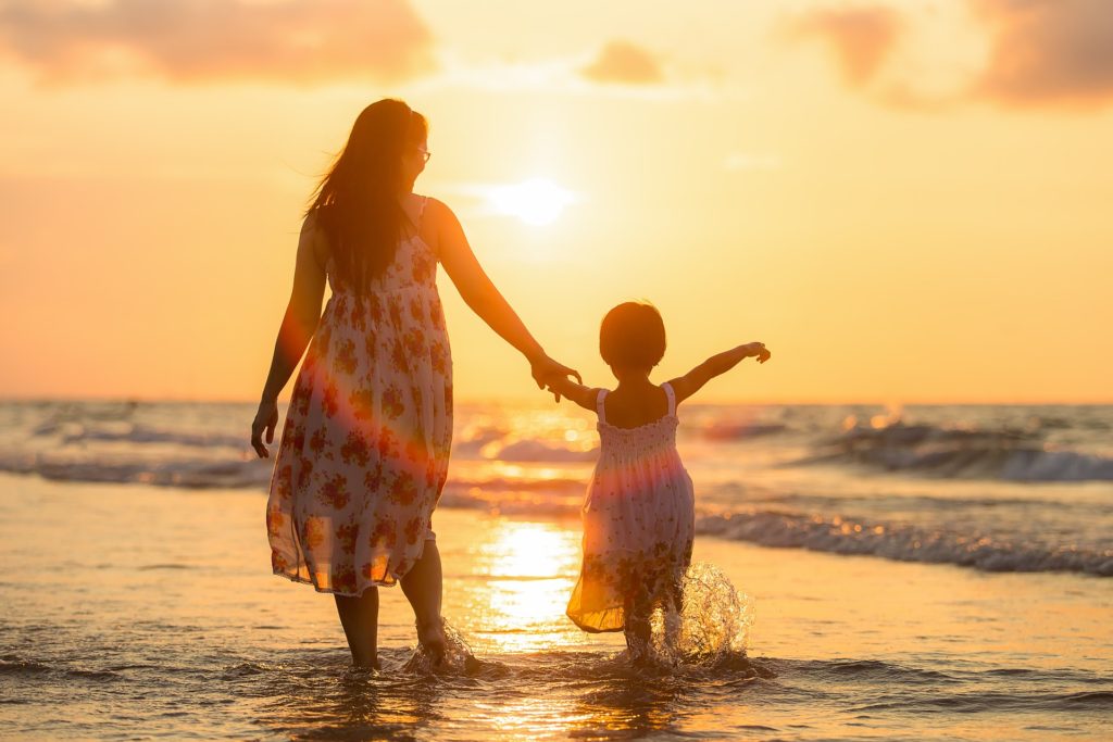 Image of mother and daughter on beach depicting importance of holidays