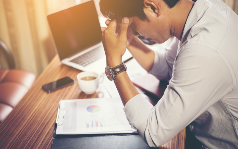 A man at work suffering from work related stress