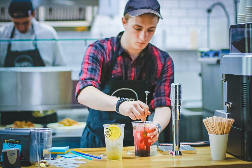 Image of a person making drinks in a restaurant for employee wellbeing survey